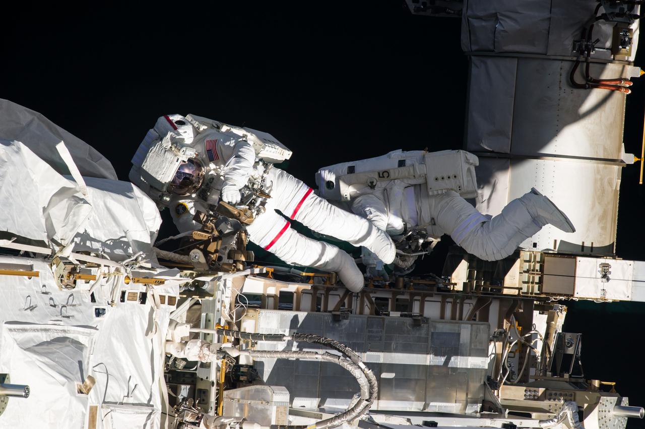 ISS035-E-036810 (11 May 2013) --- Expedition 35 Flight Engineers Chris Cassidy (left) and Tom Marshburn completed a space walk at 2:14 p.m. EDT May 11 to inspect and replace a pump controller box on the International Space Station?s far port truss (P6) leaking ammonia coolant. The two NASA astronauts began the 5-hour, 30-minute space walk at 8:44 a.m.