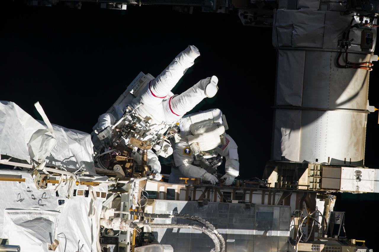 ISS035-E-036815 (11 May 2013) --- Expedition 35 Flight Engineers Chris Cassidy (left) and Tom Marshburn completed a space walk at 2:14 p.m. EDT May 11 to inspect and replace a pump controller box on the International Space Station?s far port truss (P6) leaking ammonia coolant. The two NASA astronauts began the 5-hour, 30-minute space walk at 8:44 a.m.