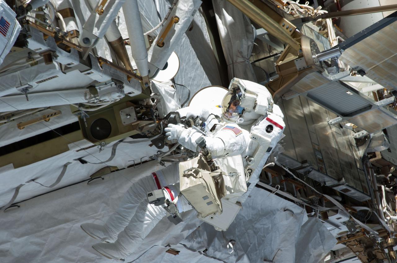 ISS035-E-037731 (11 May 2013) --- Expedition 35 Flight Engineers Chris Cassidy (pictured) and Tom Marshburn (out of frame) completed a space walk at 2:14 p.m. EDT May 11 to inspect and replace a pump controller box on the International Space Station's far port truss (P6) leaking ammonia coolant. The two NASA astronauts began the 5-hour, 30-minute space walk at 8:44 a.m.