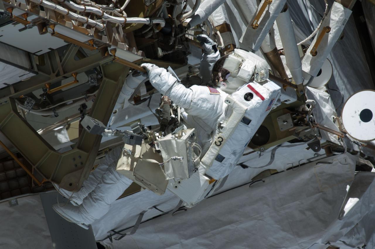 ISS035-E-037733 (11 May 2013) --- Expedition 35 Flight Engineers Chris Cassidy (pictured) and Tom Marshburn (out of frame) completed a space walk at 2:14 p.m. EDT May 11 to inspect and replace a pump controller box on the International Space Station's far port truss (P6) leaking ammonia coolant. The two NASA astronauts began the 5-hour, 30-minute space walk at 8:44 a.m.