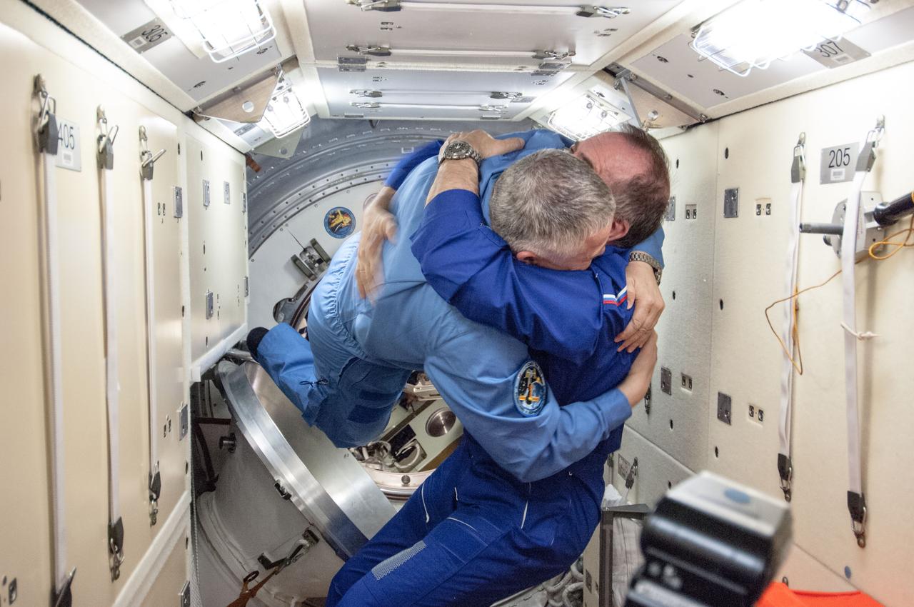 ISS036-E-004756 (29 May 2013) --- A mini reunion of cosmonauts takes place in the Rassvet Mini-Research Module (MRM1) aboard the International Space Station a short while after a Soyuz TMA-09M spacecraft delivered the second three-person component of the Expedition 36 crew. Expedition 36 Flight Engineer and assigned Expedition 37 Commander Fyodor Yurchikhin (left) gets a warm greeting from Expedition 36 Commander Pavel Vinogradov. Expedition 36 now has a full complement of six crew members.