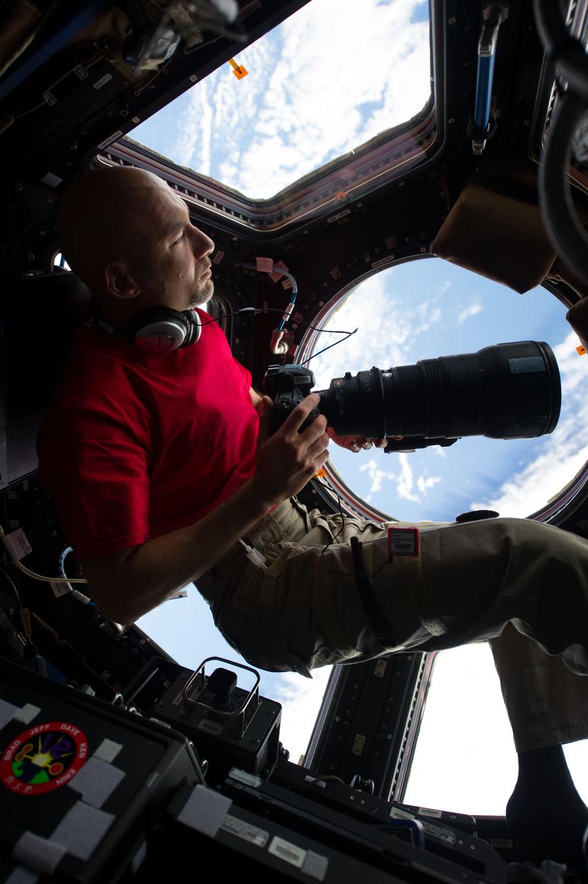 ISS036-E-005771 (2 June 2013) --- Inside the Cupola, European Space Agency astronaut Luca Parmitano, an Expedition 36 flight engineer, eyeballs a point on Earth some 250 miles below him and the International Space Station before  pinpointing a specific photo target of opportunity. He holds a digital still camera, equipped with a 400mm lens. Parmitano has been on board the orbital outpost for about three days and will continue his stay into November