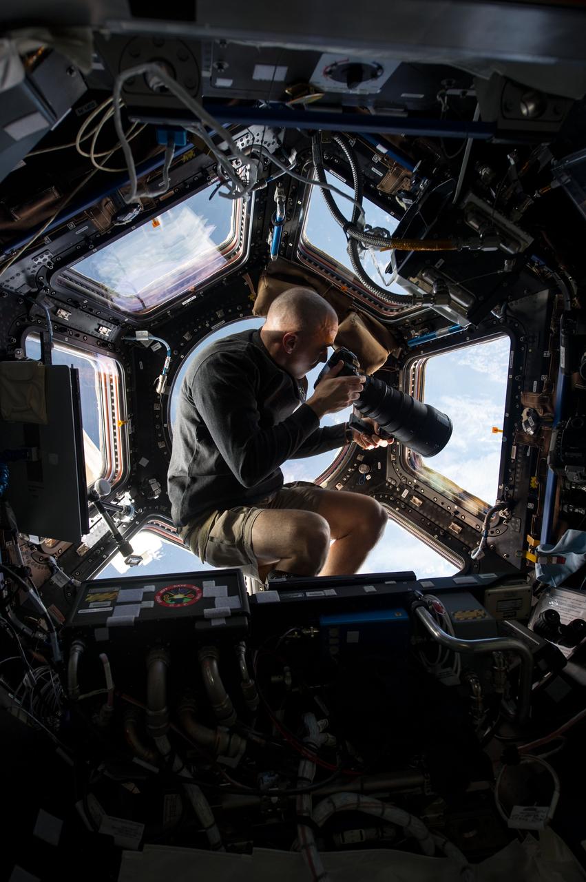 ISS036-E-006166 (3 June 2013) --- Inside the Cupola, NASA astronaut Chris Cassidy, an Expedition 36 flight engineer, uses a 400mm lens on a digital still camera to photograph a target of opportunity on Earth some 250 miles below him and the International Space Station. Cassidy has been aboard the orbital outpost since late March and will continue his stay into September.