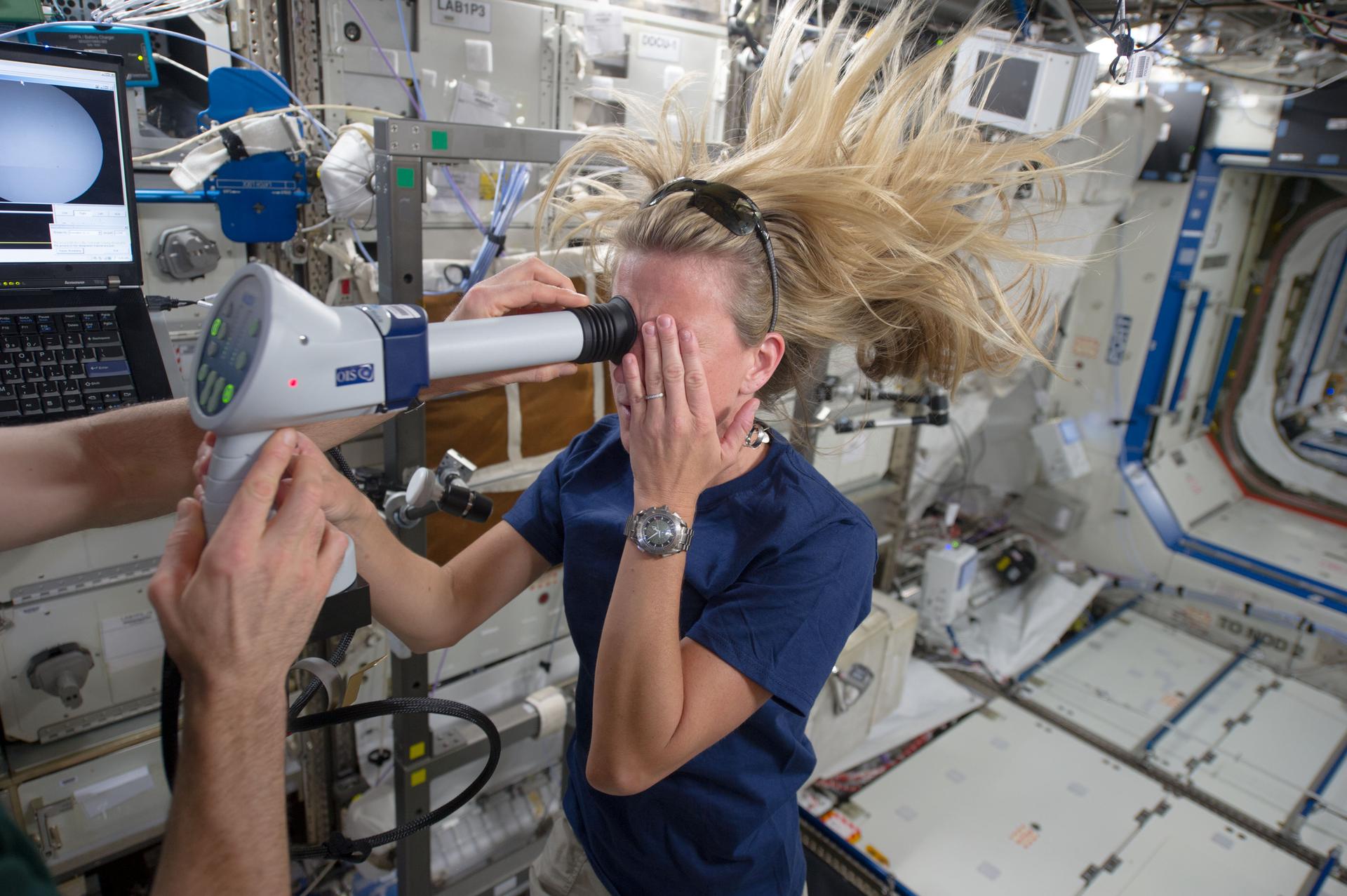 Expedition 36/37 astronaut Karen Nyberg uses a fundoscope to take still and video images of her eye while in orbit. Credit: NASA