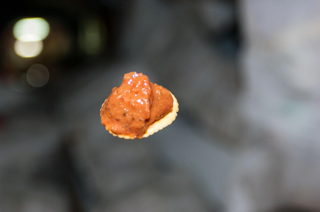 View of a cracker with food topping floating in an ISS modules as documented by the Expedition 36 crew.