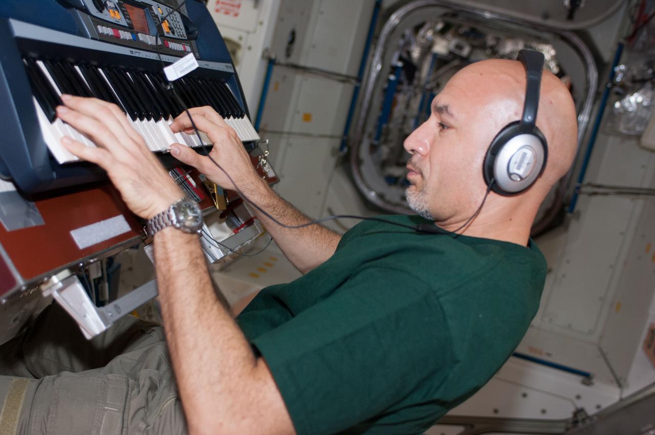 ISS036-E-007233 (12 June 2013) --- European Space Agency astronaut Luca Parmitano, Expedition 36 flight engineer, plays a keyboard instrument in the Unity node during some of his off-duty time aboard the Earth-orbiting International Space Station. Parmitano is scheduled to stay aboard the orbital outpost until November.