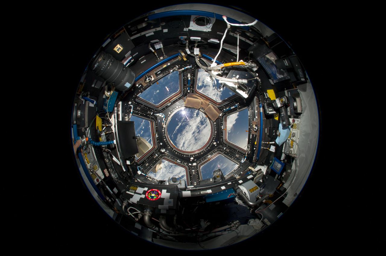 ISS036-E-007470 (12 June 2013) --- This wide view of the seven windows of the International Space Station’s Cupola serves to give a paneled look of Earth, in this case, a point in the South Atlantic. The Cupola is used to conduct experiments, dockings and observations of Earth such as this. The observatory was launched aboard STS-130 on Feb. 8 2010 and attached to the Tranquility  node.