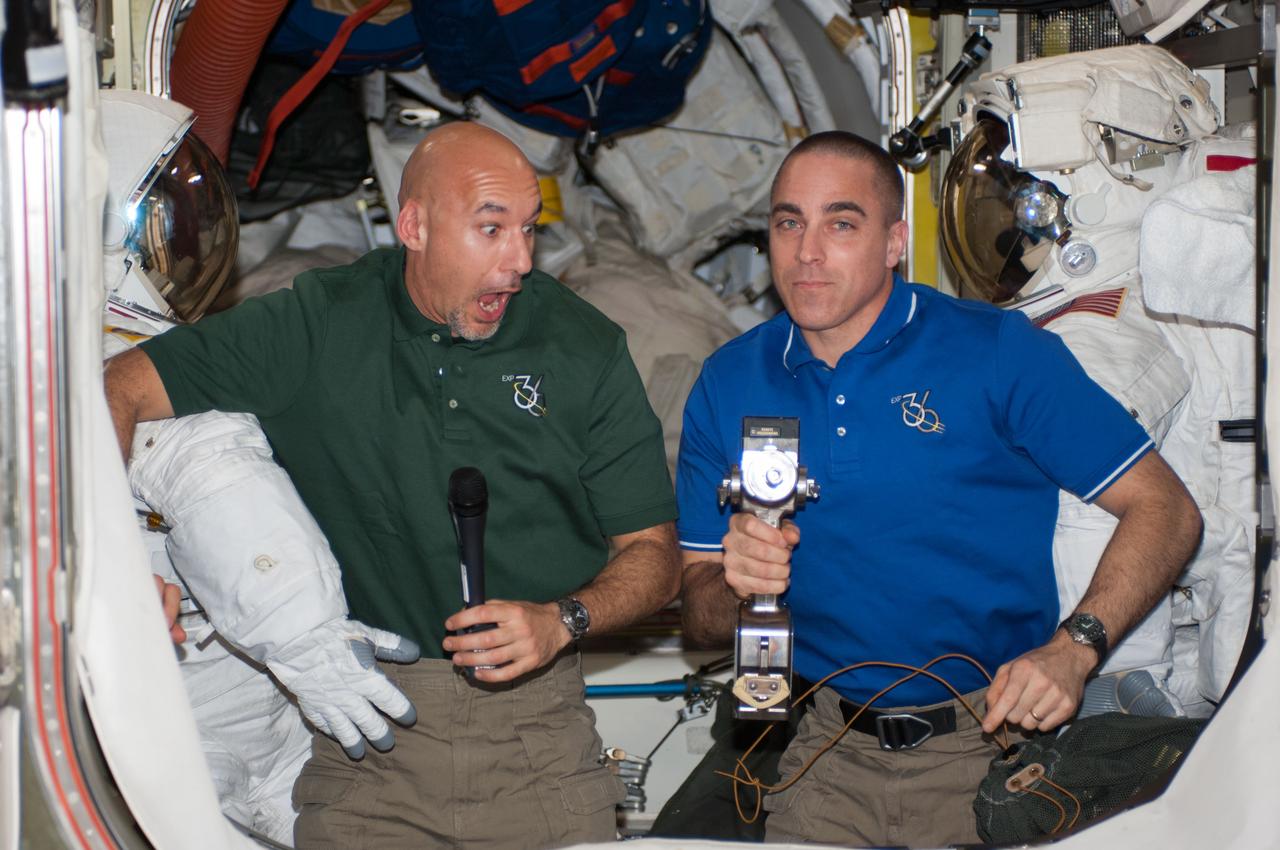 European Space Agency astronaut Luca Parmitano (left) and Astronaut Chris Cassidy,both Expedition 36 flight engineers,pose for a candid photo with Extravehicular Mobility Unit (EMU) hardware in the Quest Airlock.