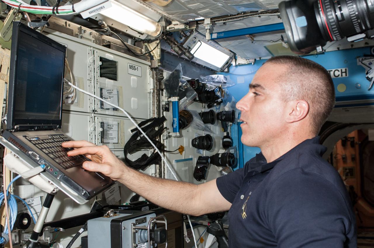 ISS036-E-008906 (17 June 2013) --- NASA astronaut Chris Cassidy, Expedition 36 flight engineer, uses a computer in the Destiny laboratory of the International Space Station.