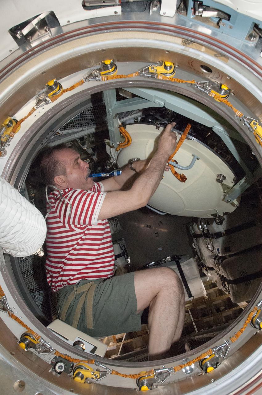 ISS036-E-009184 (18 June 2013) --- Russian cosmonaut Pavel Vinogradov, Expedition 36 commander, opens the hatch in the Zvezda Service Module transfer tunnel/ATV vestibule of the International Space Station after European Space Agency's Automated Transfer Vehicle-4 (ATV-4) "Albert Einstein" docked with the station.