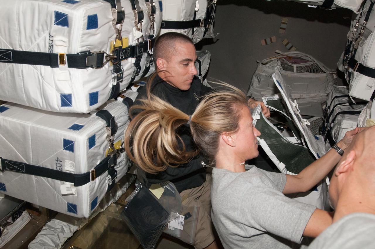 ISS036-E-009256 (18 June 2013) --- NASA astronauts Chris Cassidy and Karen Nyberg, both Expedition 36 flight engineers, perform cargo operations in the European Space Agency's Automated Transfer Vehicle-4 (ATV-4) "Albert Einstein" currently docked to the Zvezda Service Module of the International Space Station.