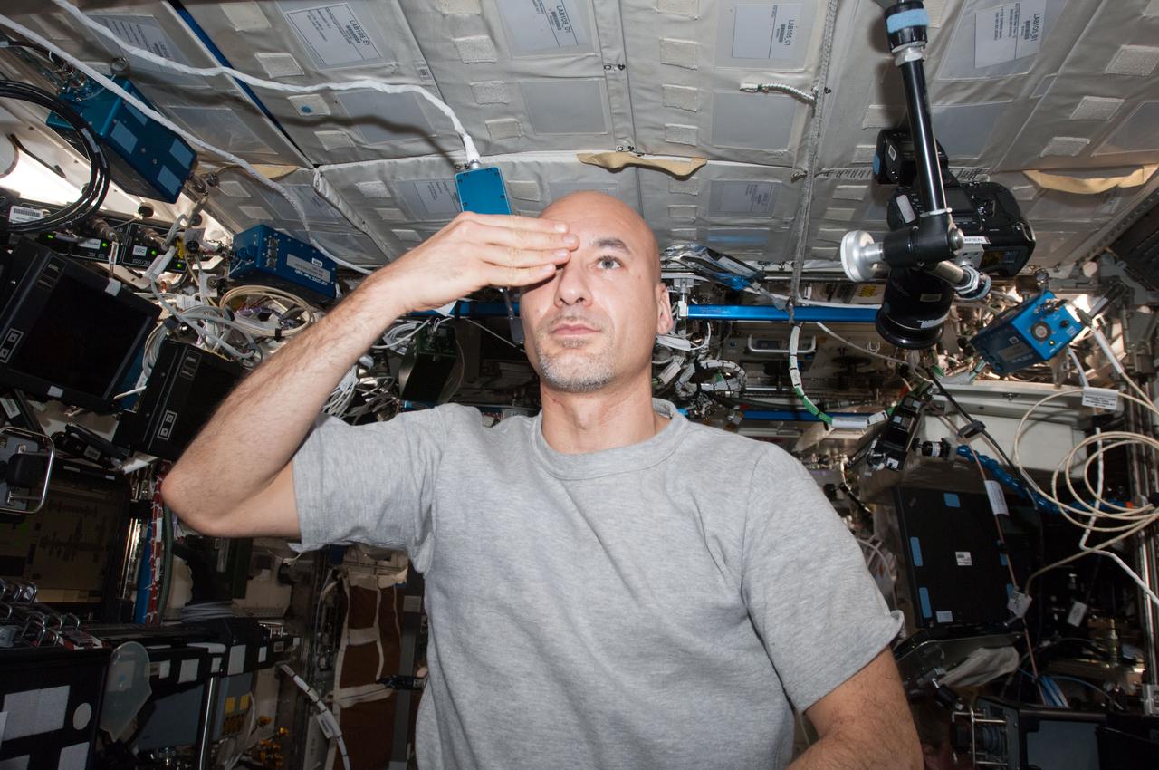 ISS036-E-010398 (24 June 2013) --- European Space Agency astronaut Luca Parmitano, Expedition 36 flight engineer, performs a visual exam using an eye chart (out of frame) in the Destiny laboratory of the International Space Station.