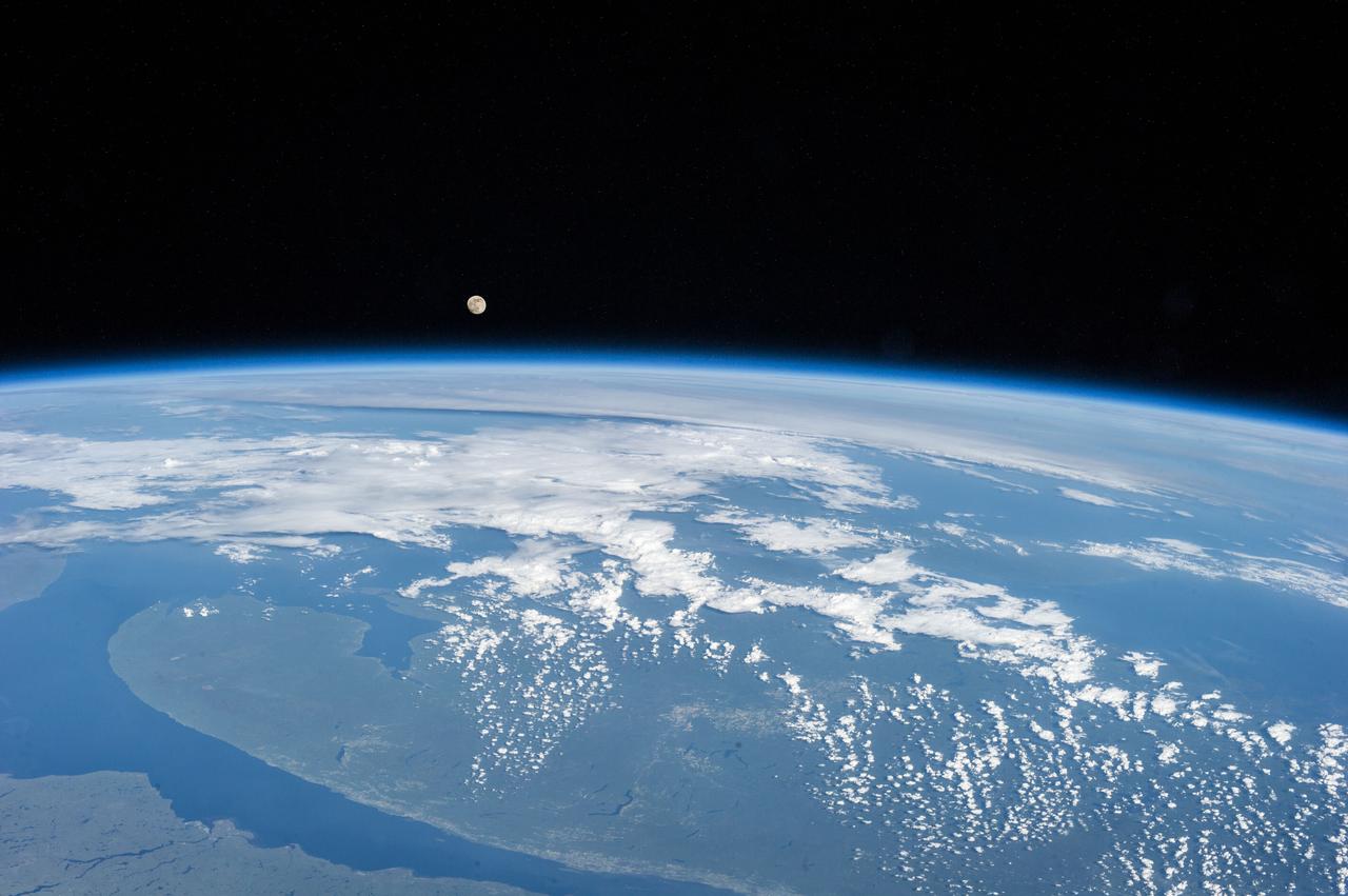 Earth observation taken during a day pass by an Expedition 36 crew member on board the International Space Station (ISS). The moon is visible in the distance.