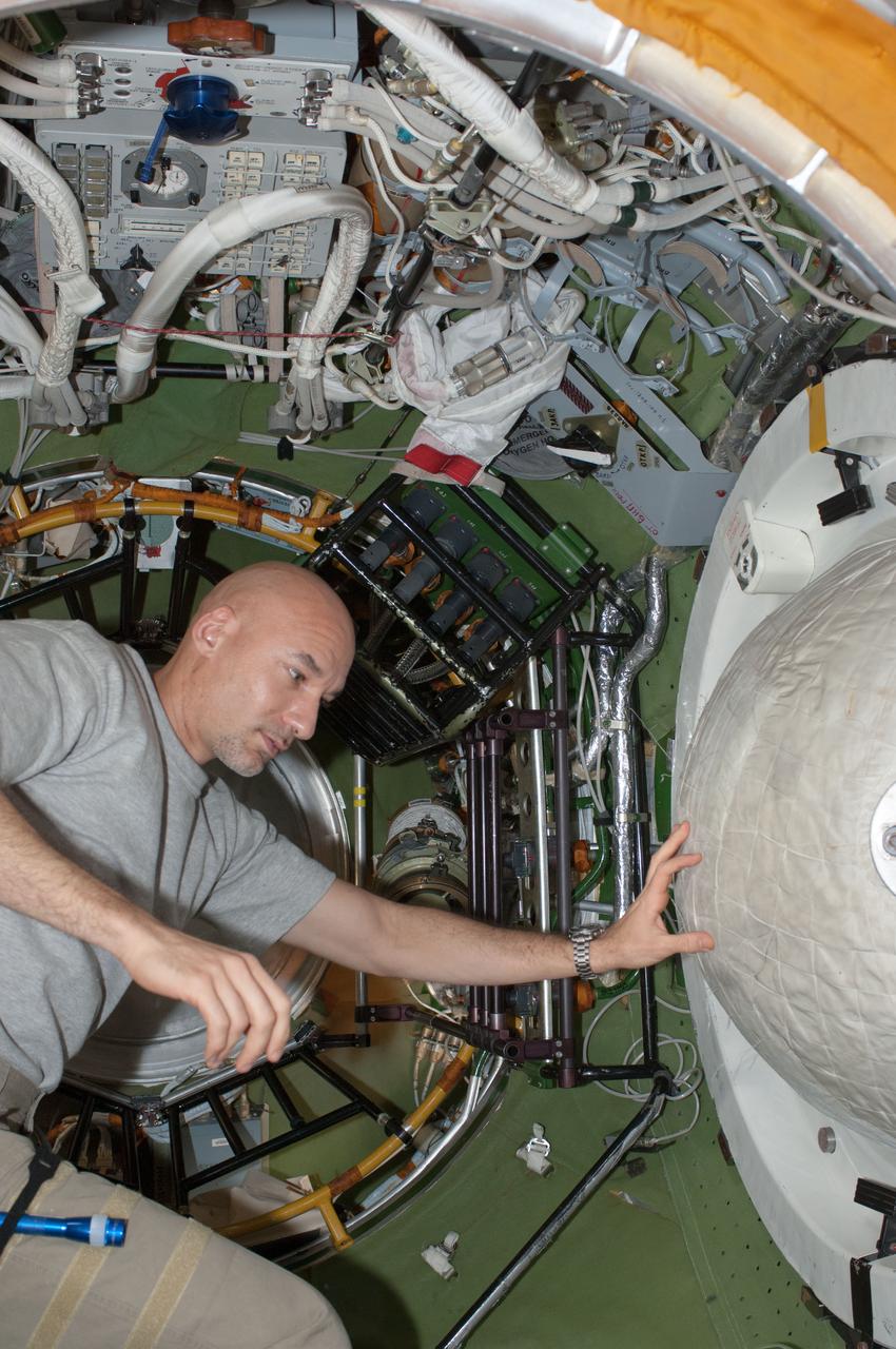 ISS036-E-011512 (24 June 2013) --- European Space Agency astronaut Luca Parmitano, Expedition 36 flight engineer, works in the transfer compartment between the Zarya Functional Cargo Block (FGB) and the Zvezda Service Module of the International Space Station.