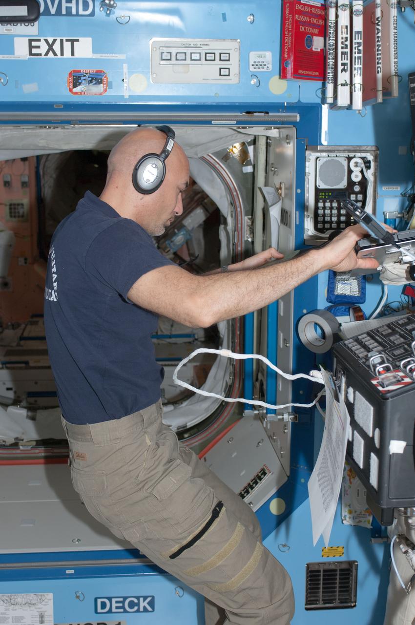 ISS036-E-011520 (24 June 2013) --- European Space Agency astronaut Luca Parmitano, Expedition 36 flight engineer, enters data on a computer during an acoustic survey, using a U.S. Sound Level Meter (SLM), in the Destiny laboratory of the International Space Station.