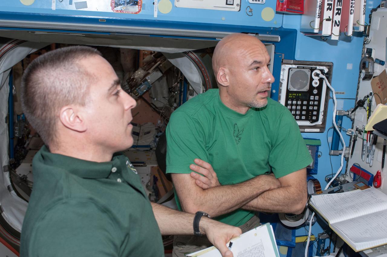 ISS036-E-012131 (25 June 2013) --- NASA astronaut Chris Cassidy (left) and European Space Agency astronaut Luca Parmitano, both Expedition 36 flight engineers, perform a Portable Onboard Computers (POC) Dynamic Onboard Ubiquitous Graphics (DOUG) software review in preparation for spacewalks scheduled for July 9 and July 16.