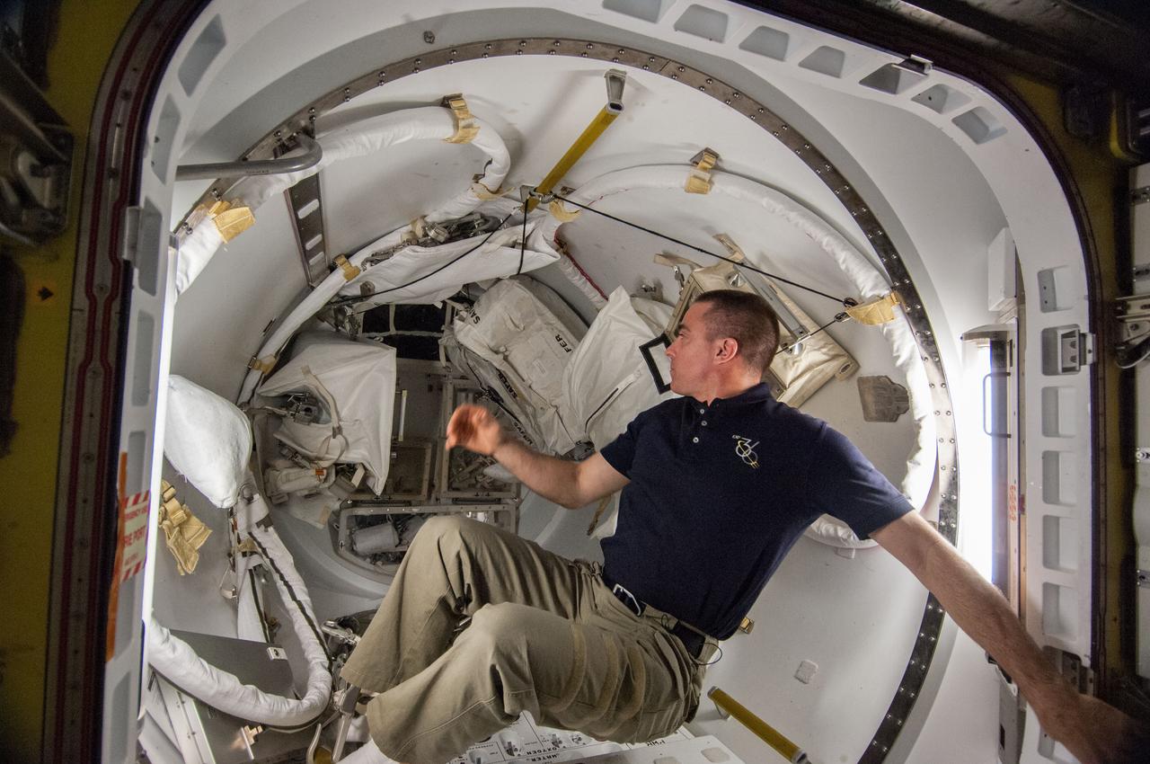 ISS036-E-013051 (30 June 2013) --- NASA astronaut Chris Cassidy, Expedition 36 flight engineer, works with spacewalk equipment in the Quest airlock of the International Space Station in preparation for the first of two sessions of extravehicular activity (EVA) scheduled for July 9 and July 16.