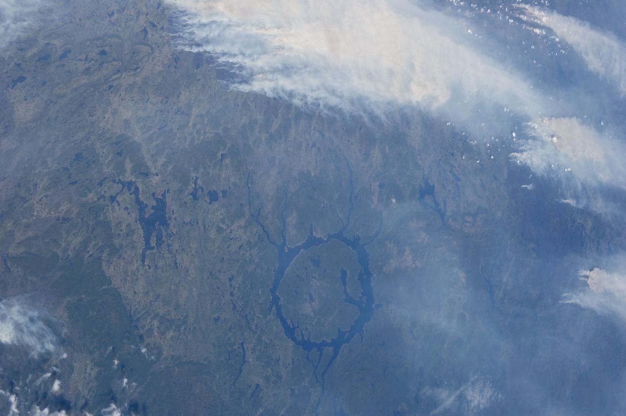 ISS036-E-015355 (4 July 2013) ---  A number of Quebec, Canada wildfires  near the Manicouagan Reservoir (seen at bottom center) were recorded in a series of photographs taken and downlinked to Earth on July 4 by the Expedition 36 crew members aboard the International Space Station.