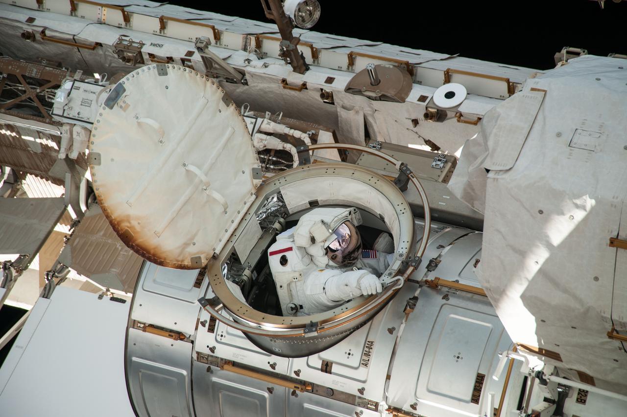 ISS036-E-016526 (9 July 2013) --- NASA astronaut Chris Cassidy, Expedition 36 flight engineer, exits the Quest airlock for a session of extravehicular activity (EVA) as work continues on the International Space Station. During the six-hour, seven-minute spacewalk, Cassidy and European Space Agency astronaut Luca Parmitano (out of frame), flight engineer, prepared the space station for a new Russian module and performed additional installations on the station’s backbone.