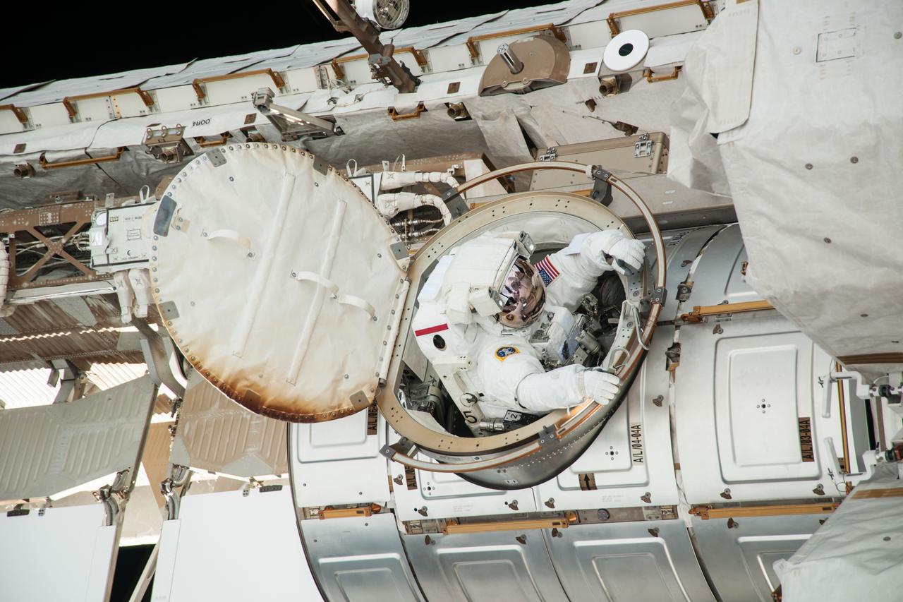 ISS036-E-016527 (9 July 2013) --- NASA astronaut Chris Cassidy, Expedition 36 flight engineer, exits the Quest airlock for a session of extravehicular activity (EVA) as work continues on the International Space Station. During the six-hour, seven-minute spacewalk, Cassidy and European Space Agency astronaut Luca Parmitano (out of frame), flight engineer, prepared the space station for a new Russian module and performed additional installations on the station’s backbone.