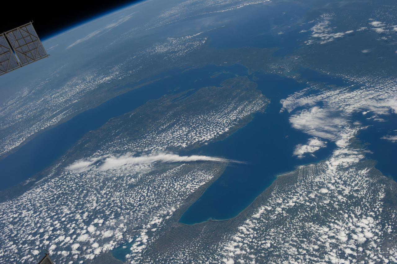 ISS036-E-017925 (11 July 2013) --- One of the Expedition 36 crew members aboard the Earth-orbiting International Space Station on July 11 captured this high oblique view of Lake Michigan (left) and Lake Huron and much of the state of Michigan in between.