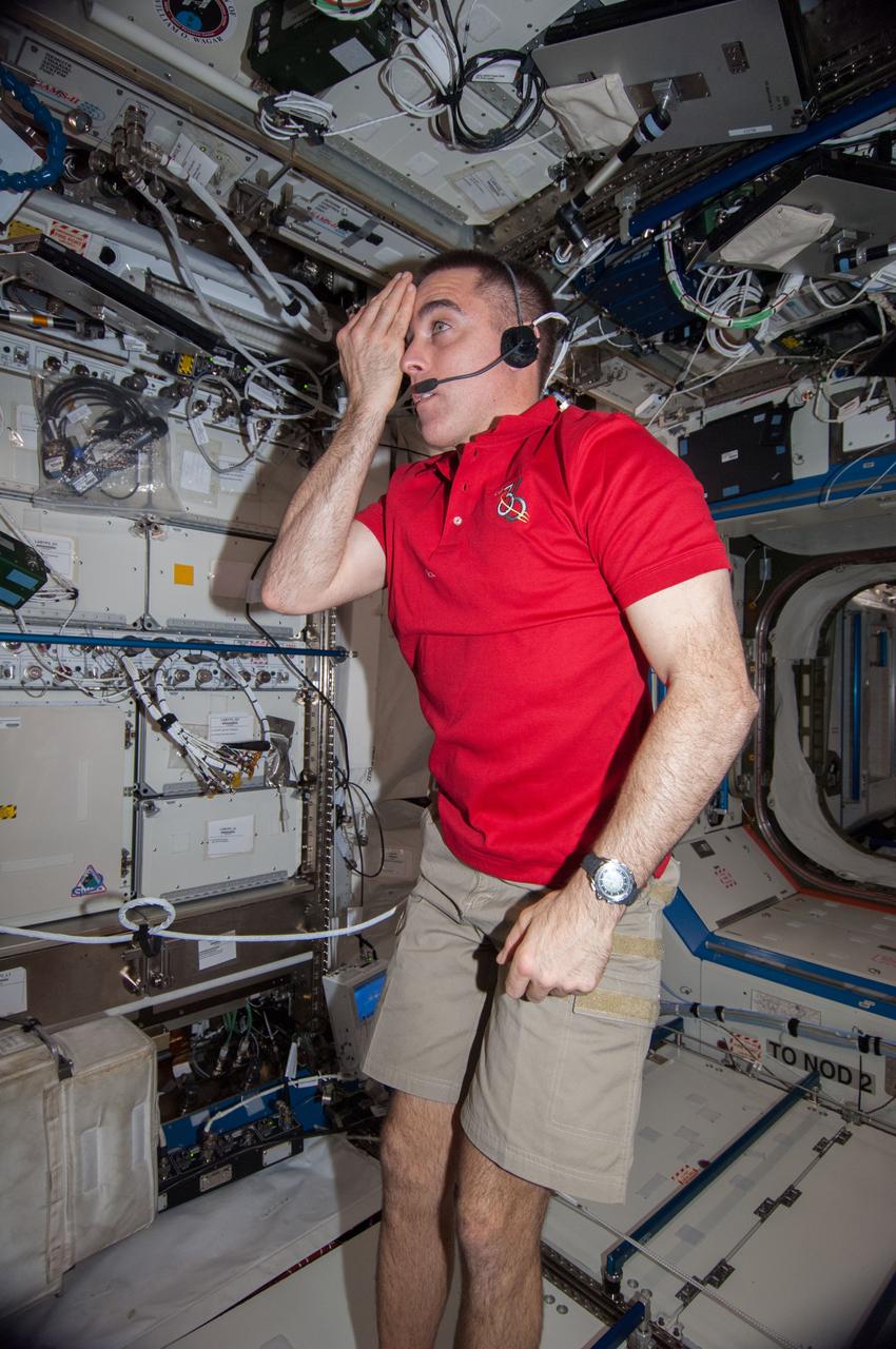 ISS036-E-018262 (11 July 2013) --- NASA astronaut Chris Cassidy, Expedition 36 flight engineer, performs a visual exam using an eye chart (out of frame) in the Destiny laboratory of the International Space Station.