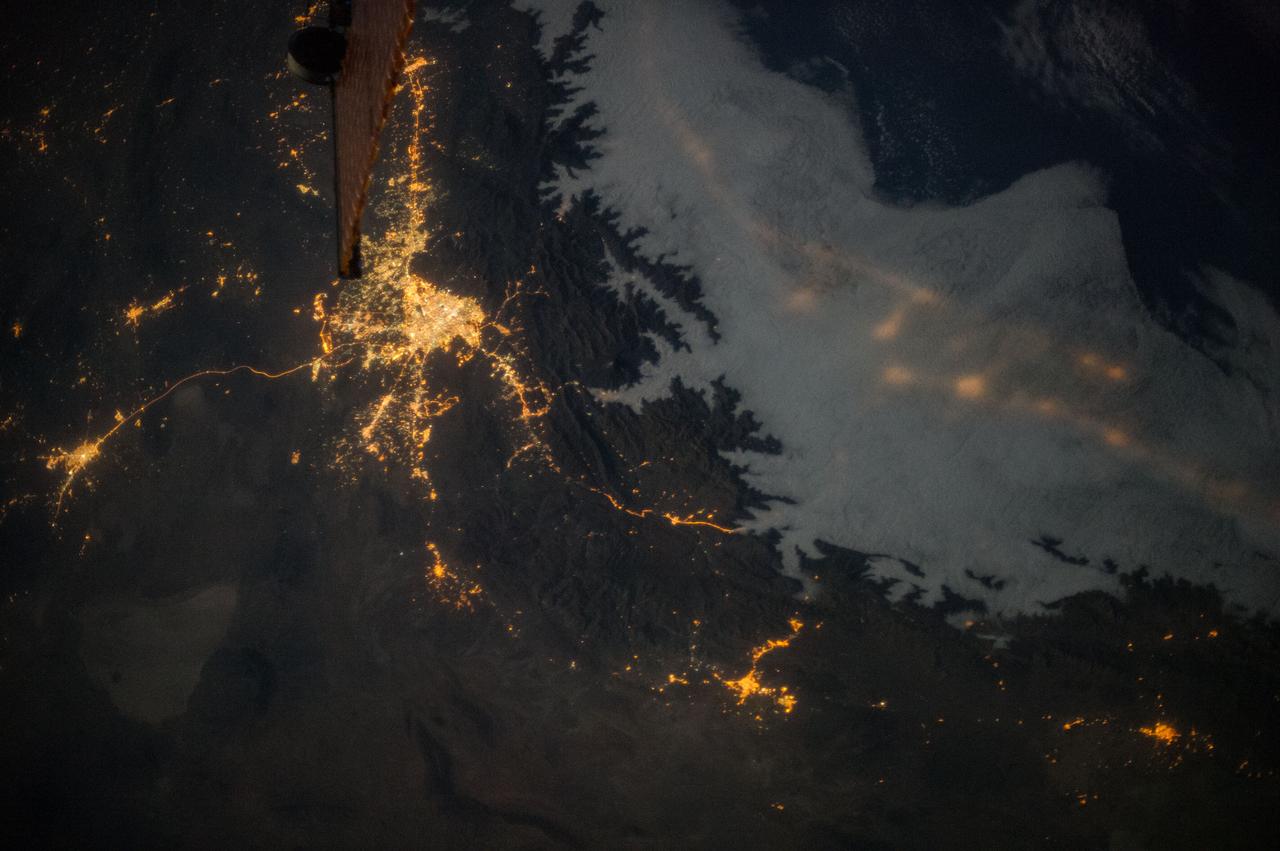 Earth observation taken during night pass by an Expedition 36 crew member on board the International Space Station (ISS).   Per Twitter message this is labeled as : Tehran, Iran. Lights along the coast of the Caspian Sea visible through clouds. July 21.