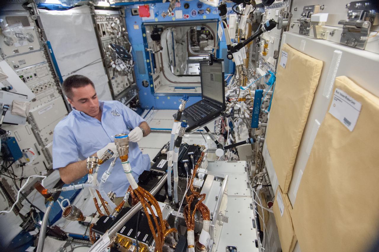 ISS036-E-023070 (23 July 2013) --- NASA astronaut Chris Cassidy, Expedition 36 flight engineer, works to remove the Marangoni Inside (MI) from the Fluid Physics Experiment Facility (FPEF) in the Kibo laboratory of the International Space Station.