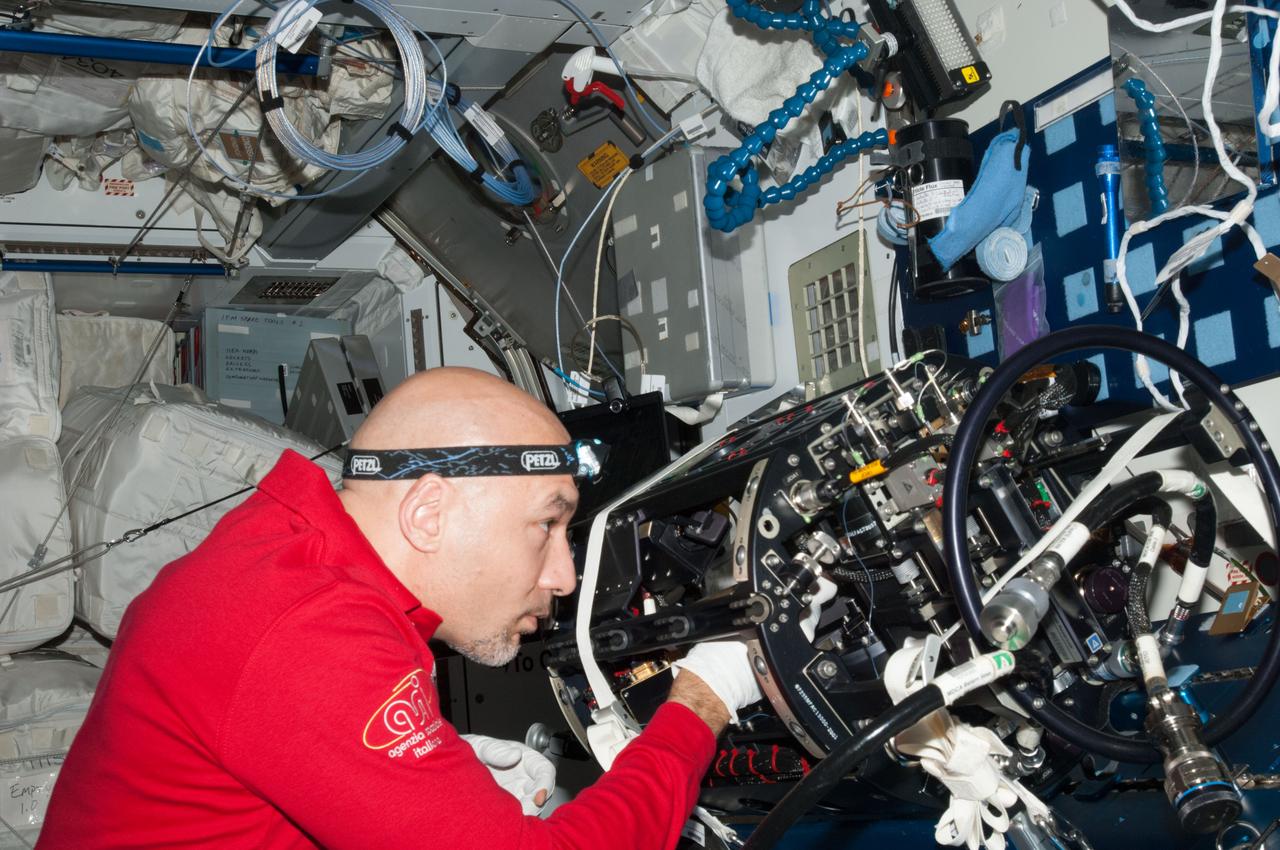 ISS036-E-024605 (24 July 2013) --- European Space Agency astronaut Luca Parmitano, Expedition 36 flight engineer, works on the Multi-User Droplet Combustion Apparatus (MDCA) Chamber Insert Assembly (CIA) at a maintenance work station in the Harmony node of the International Space Station.