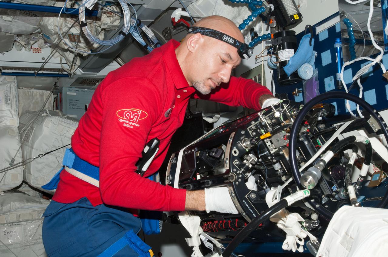ISS036-E-024637 (24 July 2013) --- European Space Agency astronaut Luca Parmitano, Expedition 36 flight engineer, works on the Multi-User Droplet Combustion Apparatus (MDCA) Chamber Insert Assembly (CIA) at a maintenance work station in the Harmony node of the International Space Station.