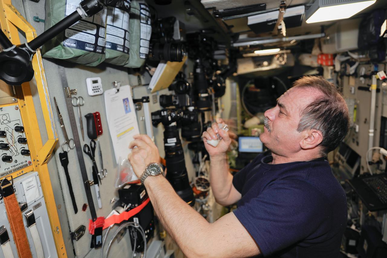 ISS036-E-024880 (29 July 2013) --- Russian cosmonaut Pavel Vinogradov, Expedition 36 commander, reads a procedures checklist in the Zvezda Service Module of the International Space Station.