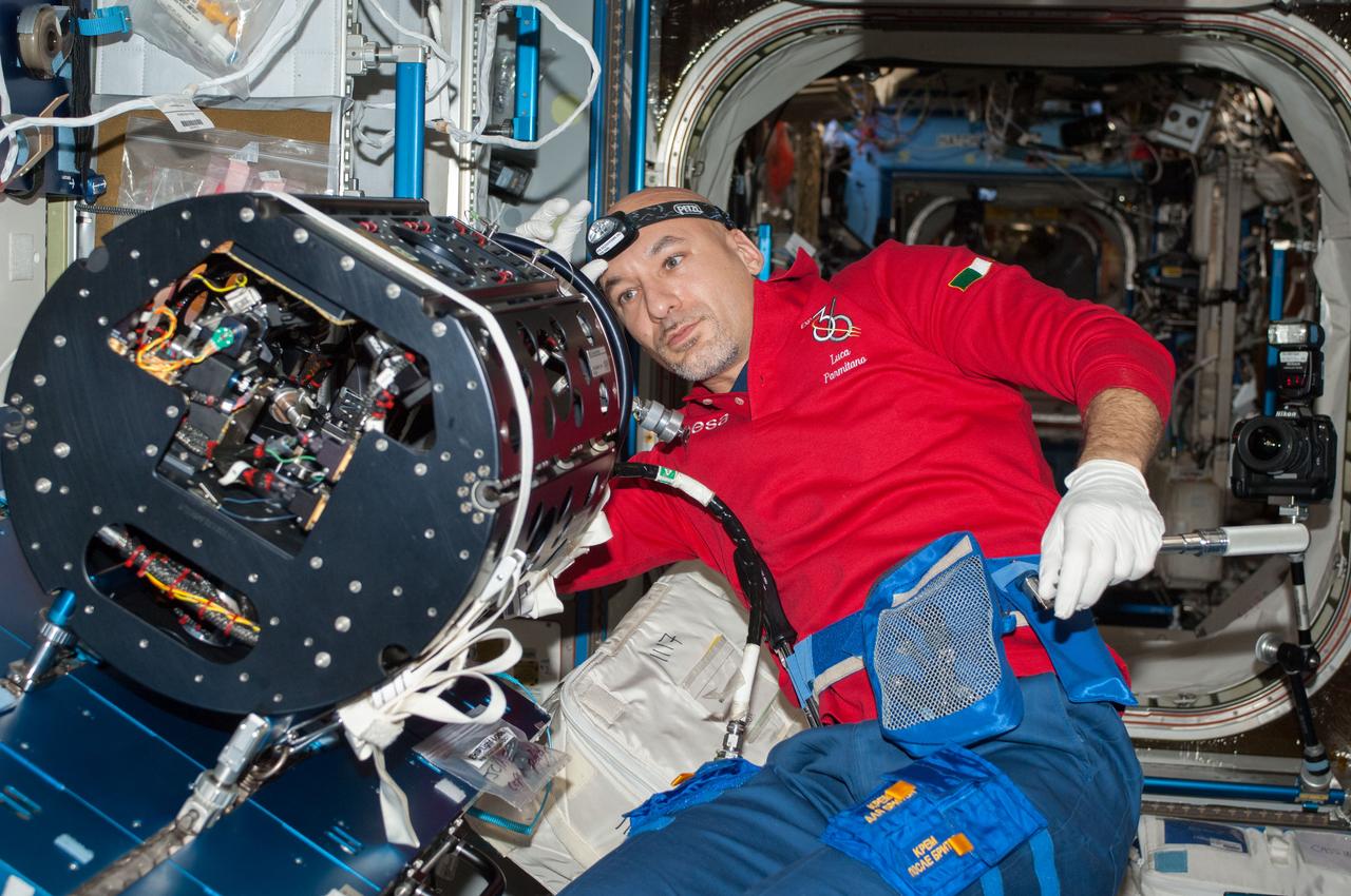 ISS036-E-025481 (24 July 2013) --- European Space Agency astronaut Luca Parmitano, Expedition 36 flight engineer, works on the Multi-User Droplet Combustion Apparatus (MDCA) Chamber Insert Assembly (CIA) at a maintenance work station in the Harmony node of the International Space Station.
