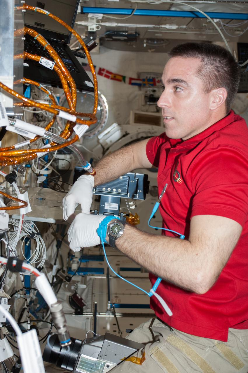 ISS036-E-025484 (24 July 2013) --- NASA astronaut Chris Cassidy, Expedition 36 flight engineer, performs in-flight maintenance on the Marangoni Inside experiment in the Fluid Physics Experiment Facility (FPEF) which is part of a Japanese science rack in the International Space Station?s Kibo laboratory.