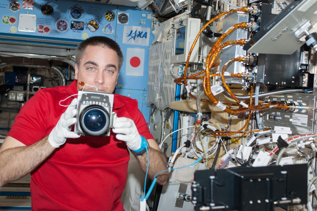 ISS036-E-025487 (24 July 2013) --- NASA astronaut Chris Cassidy, Expedition 36 flight engineer, performs in-flight maintenance on the Marangoni Inside experiment in the Fluid Physics Experiment Facility (FPEF) which is part of a Japanese science rack in the International Space Station?s Kibo laboratory.
