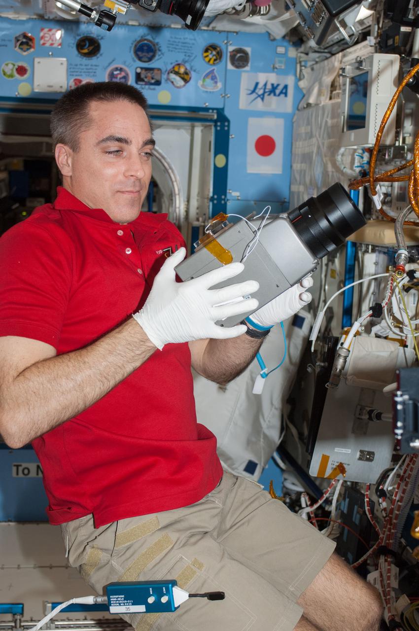 ISS036-E-025489 (24 July 2013) --- NASA astronaut Chris Cassidy, Expedition 36 flight engineer, performs in-flight maintenance on the Marangoni Inside experiment in the Fluid Physics Experiment Facility (FPEF) which is part of a Japanese science rack in the International Space Station?s Kibo laboratory.