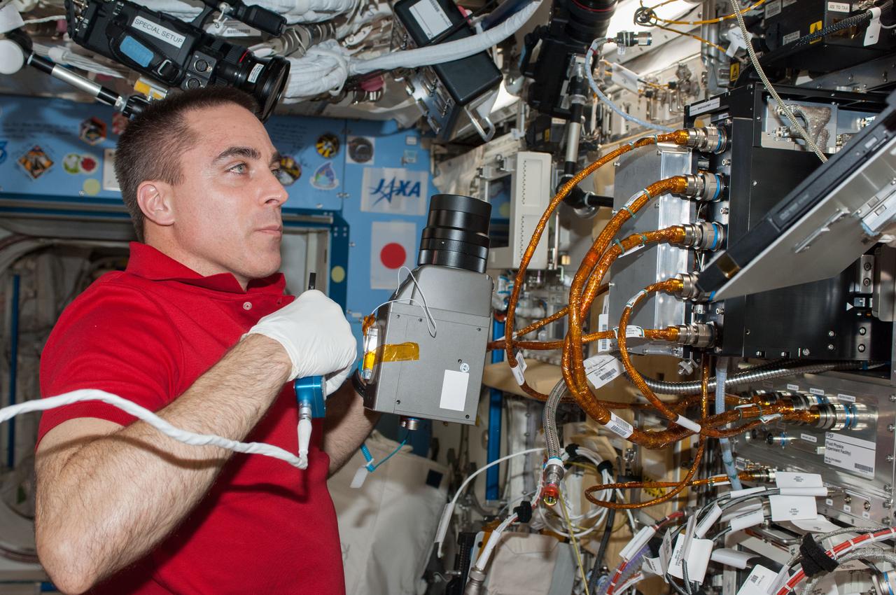 ISS036-E-025491 (24 July 2013) --- NASA astronaut Chris Cassidy, Expedition 36 flight engineer, performs in-flight maintenance on the Marangoni Inside experiment in the Fluid Physics Experiment Facility (FPEF) which is part of a Japanese science rack in the International Space Station?s Kibo laboratory.