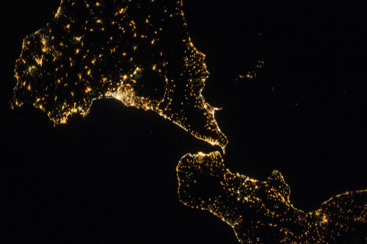 ISS036-E-025991 (29 July 2013) --- One of the Expedition 36 crew members aboard the Earth-orbiting International Space Station took this night picture of Sicily (top) and the tip of Italy's "boot" in the Mediterranean Sea on July 29, 2013.