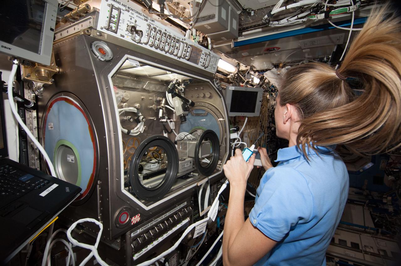 ISS036-E-027145 (1 Aug. 2013) --- NASA astronaut Karen Nyberg, Expedition 36 flight engineer, speaks in a microphone while working with the InSPACE-3 experiment in the Microgravity Science Glovebox (MSG) in the Destiny laboratory of the International Space Station. InSPACE-3 applies different magnetic fields to vials of colloids, or liquids with microscopic particles, and observes how fluids can behave like a solid. Results may improve the strength and design of materials for stronger buildings and bridges.