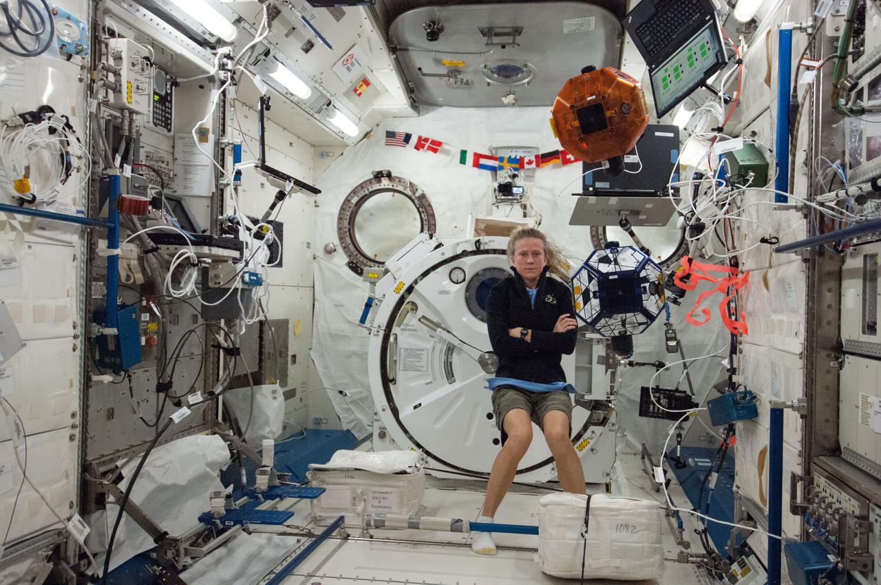 ISS036-E-029522 (7 Aug. 2013) --- In the International Space Station’s Kibo laboratory, NASA astronaut Karen Nyberg, Expedition 36 flight engineer, conducts a session with a pair of bowling-ball-sized free-flying satellites known as Synchronized Position Hold, Engage, Reorient, Experimental Satellites, or SPHERES. Nyberg and NASA astronaut Chris Cassidy (not pictured) put the miniature satellites through their paces for a dry run of the SPHERES Zero Robotics tournament scheduled for Aug. 13. Teams of middle school students from Florida, Georgia, Idaho and Massachusetts will gather at the Massachusetts Institute of Technology in Cambridge to see which teams’ algorithms do the best job of commanding the free-flying robots through a series of maneuvers and objectives.