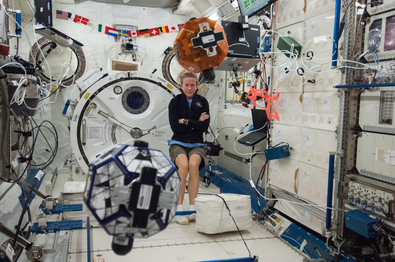 ISS036-E-029539 (7 Aug. 2013) --- In the International Space Station’s Kibo laboratory, NASA astronaut Karen Nyberg, Expedition 36 flight engineer, conducts a session with a pair of bowling-ball-sized free-flying satellites known as Synchronized Position Hold, Engage, Reorient, Experimental Satellites, or SPHERES. Nyberg and NASA astronaut Chris Cassidy (not pictured) put the miniature satellites through their paces for a dry run of the SPHERES Zero Robotics tournament scheduled for Aug. 13. Teams of middle school students from Florida, Georgia, Idaho and Massachusetts will gather at the Massachusetts Institute of Technology in Cambridge to see which teams’ algorithms do the best job of commanding the free-flying robots through a series of maneuvers and objectives.