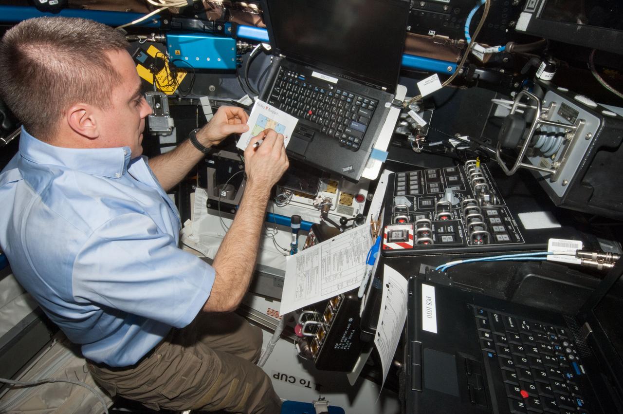 ISS036-E-029877 (9 Aug. 2013) --- NASA astronaut Chris Cassidy, Expedition 36 flight engineer, is pictured at the robotic workstation in the Cupola of the International Space Station during rendezvous operations with the approaching unpiloted Japanese "Kounotori" H2 Transfer Vehicle-4 (HTV-4).