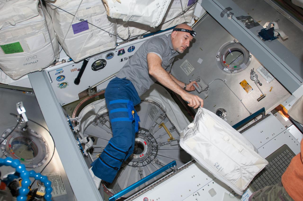 ISS036-E-030213 (9 Aug. 2013) --- European Space Agency astronaut Luca Parmitano, Expedition 36 flight engineer, prepares to open the hatch to the newly attached Japanese "Kounotori" H2 Transfer Vehicle-4 (HTV-4) docked to the International Space Station's Harmony node.
