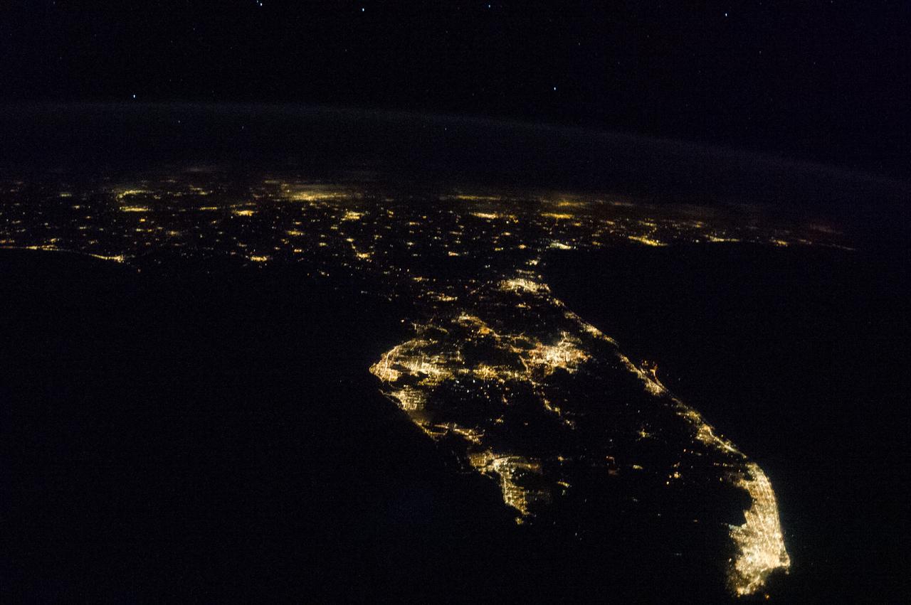 ISS036-E-030910 (10 Aug. 2013) --- One of the Expedition 36 crew members aboard the International Space Station photographed this nocturnal image of Florida and parts of the southeast United States on Aug. 10. Almost totally filled-in light strings along both Atlantic (right) and Gulf of Mexico coasts highlight the major populated areas, with the Miami metropolitan area at bottom right being the most conspicuous. The Keys are just out of frame in lower right. The Tampa Bay/St. Petersburg area is easily recognizable near frame center, and the jutting Cape Canaveral, which is home to NASA's Kennedy Space Center, is just below right center.