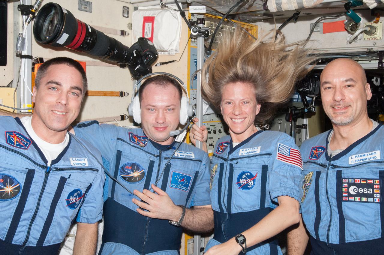 ISS036-E-032944 (15 Aug. 2013) --- NASA astronaut Chris Cassidy (left), Russian cosmonaut Alexander Misurkin, NASA astronaut Karen Nyberg and European Space Agency astronaut Luca Parmitano (right), all Expedition 36 flight engineers, pose for a portrait in the Zvezda Service Module of the International Space Station.