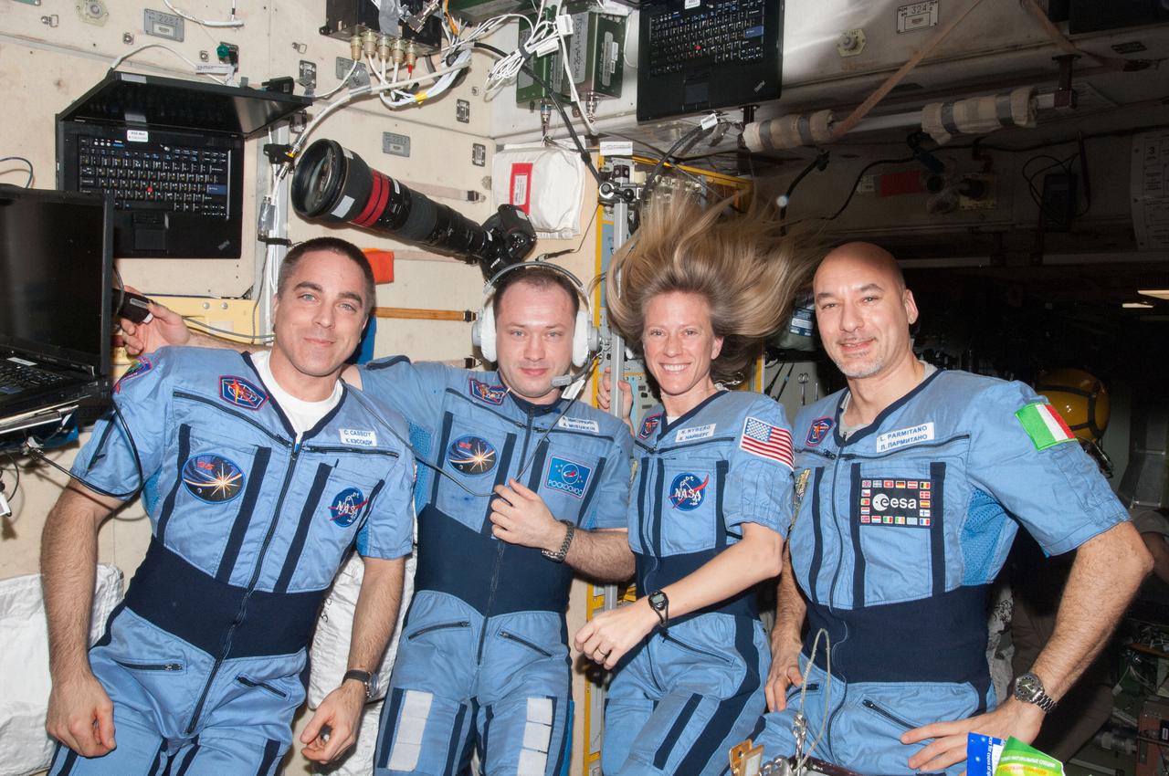 NASA astronaut Chris Cassidy (left), Russian cosmonaut Alexander Misurkin, NASA astronaut Karen Nyberg and European Space Agency astronaut Luca Parmitano (right), all Expedition 36 flight engineers, pose for a portrait in their "Penguin" suits in the Zvezda Service Module of the International Space Station. Also sent as Twitter message.