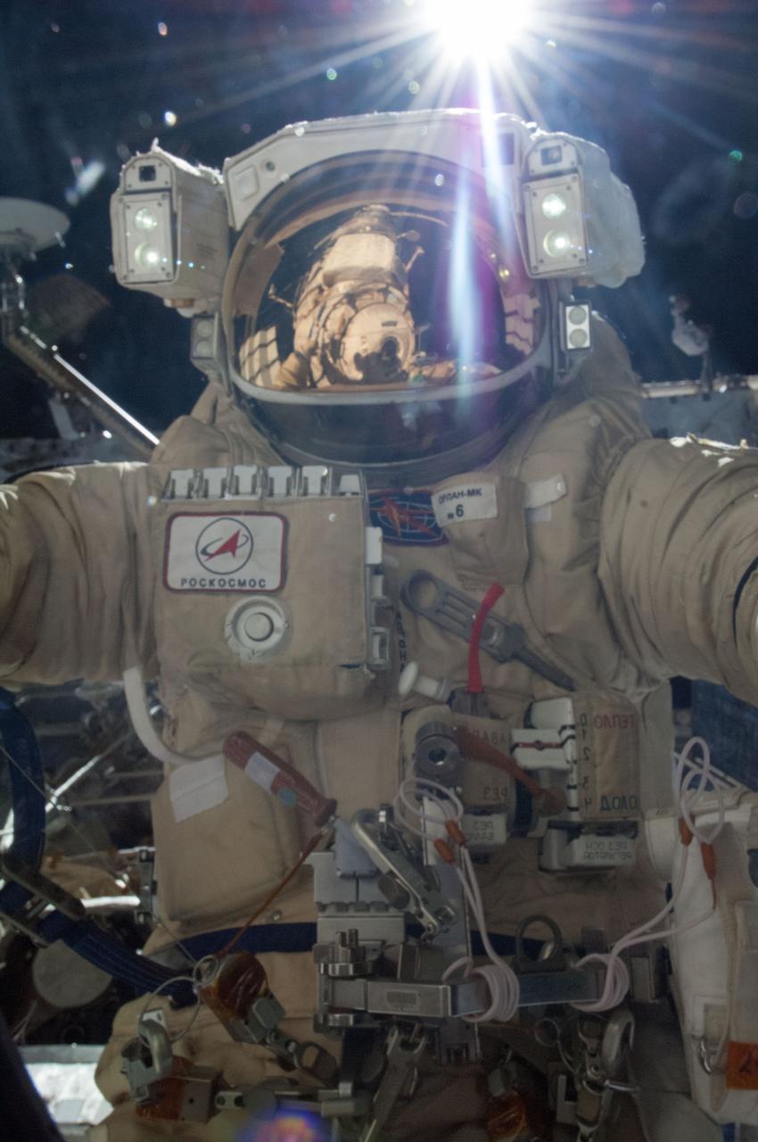 ISS036-E-035198 (22 Aug. 2013) --- Russian cosmonaut Alexander Misurkin, Expedition 36 flight engineer, attired in a Russian Orlan spacesuit, participates in a session of extravehicular activity (EVA) to continue outfitting the International Space Station. During the five-hour, 58-minute spacewalk, Misurkin and Russian cosmonaut Fyodor Yurchikhin (out of frame) completed the replacement of a laser communications experiment with a new platform for a small optical camera system, the installation of new spacewalk aids and an inspection of antenna covers. A section of the space station is visible in the reflections in his helmet visor.