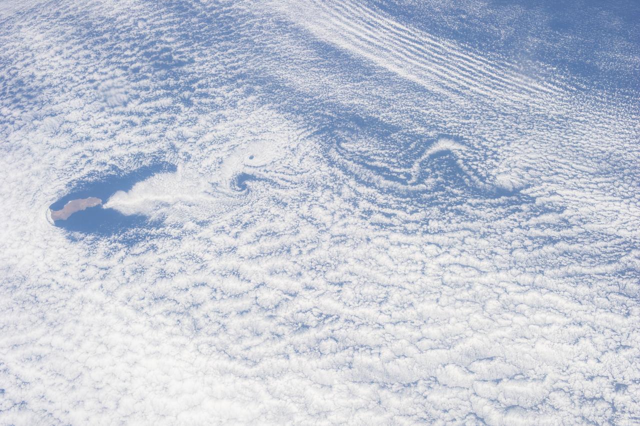ISS036-E-035663 (24 Aug. 2013) --- One of the Expedition 36 crew members aboard the  International Space Station recorded this still image of unusual cloud patterns surrounding Guadalupe Island in the Pacific Ocean (left center).  These are the result of  a ubiquitous occurrence in the motion of fluids—a vortex street, which is a linear chain of spiral eddies called von Karman vortices. Von Karman vortices are named after Theodore von Karman, a co-founder of NASA's Jet Propulsion Laboratory. who first described the phenomenon in the atmosphere.  Guadalupe Island or Isla Guadalupe is a volcanic island located 241 kilometers (150 statute miles) off the west coast of Mexico's Baja California peninsula.