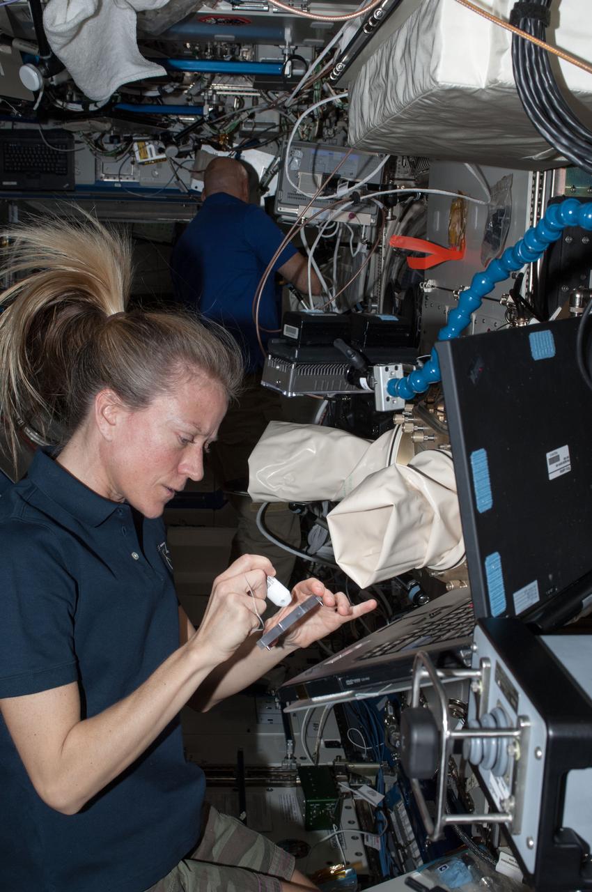ISS036-E-035770 (18 Aug. 2013) --- NASA astronaut Karen Nyberg, Expedition 36 flight engineer, works with new test samples for the Advanced Colloids Experiment, or ACE, housed in the Light Microscopy Module (LMM) inside the Fluids Integrated Rack of the International Space Station?s Destiny laboratory. Results from ACE will help researchers understand how to optimize stabilizers to extend the shelf life of products like laundry detergent, paint, ketchup and even salad dressing.