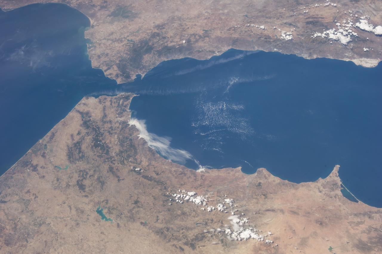 ISS036-E-036611 (23 Aug. 2013) --- One of the Expedition 36 crew members aboard the International Space Station on Aug. 23 exposed this image of the Strait of Gibraltar, where Europe and Africa meet and where the Atlantic Ocean waters flow through the strait into the Mediterranean Sea. A popular photographic target of astronauts has always been the Strait of Gibraltar, easily spotted at left center in this wide photograph, shot from the International Space Station. Spain is to the north (top) and Morocco to the south. The strait is 36 miles (58 kilometers) long and slims down to 8 miles (13 kilometers) at it?s most narrow point. The British colony of Gibraltar is north of the strait.