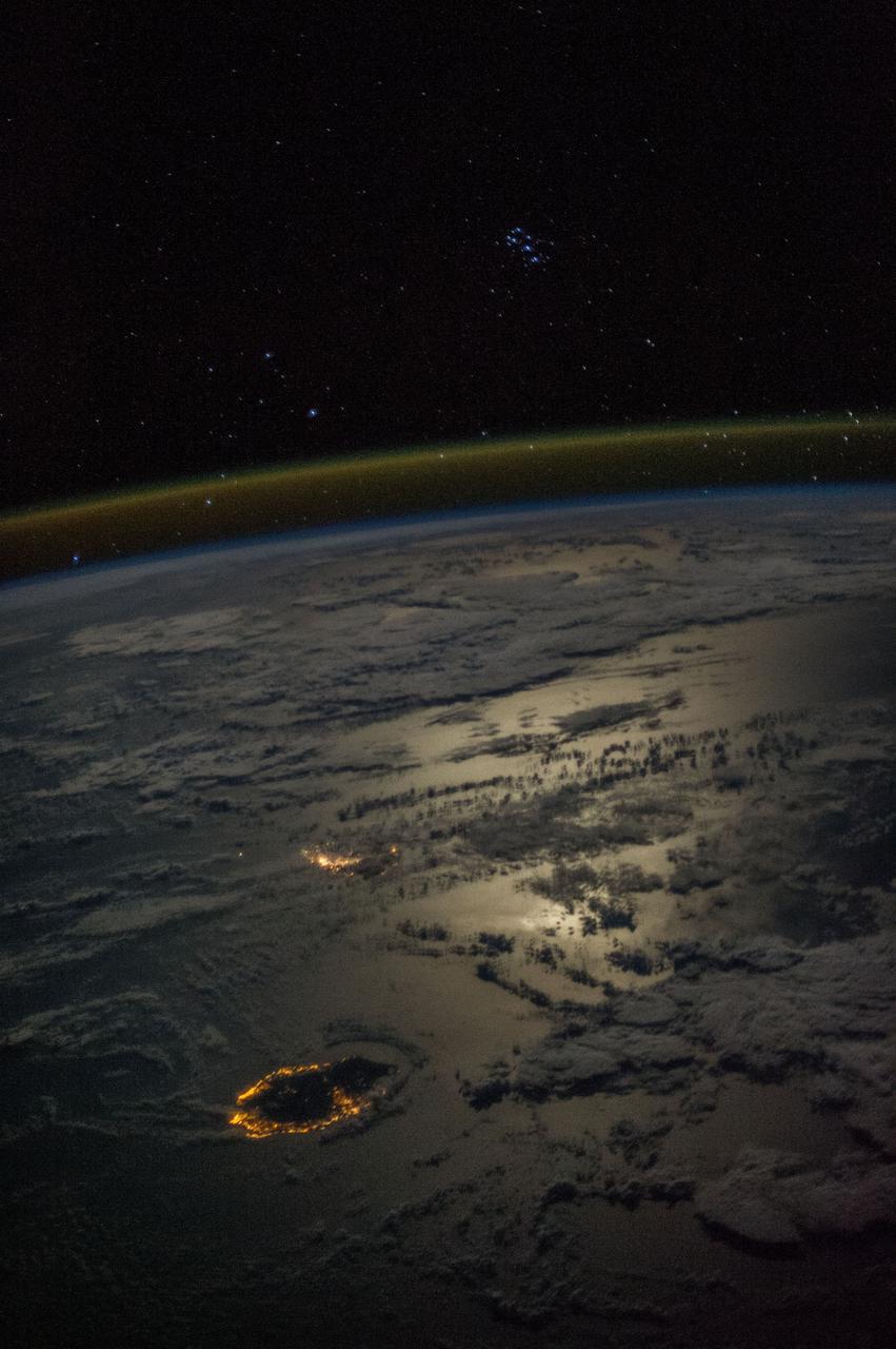 Earth observation taken during a night pass by the Expedition 36 crew.  Per Twitter message: Seven Sisters overlooking Reunion & Mauritius Islands in a moonlit Indian Ocean.